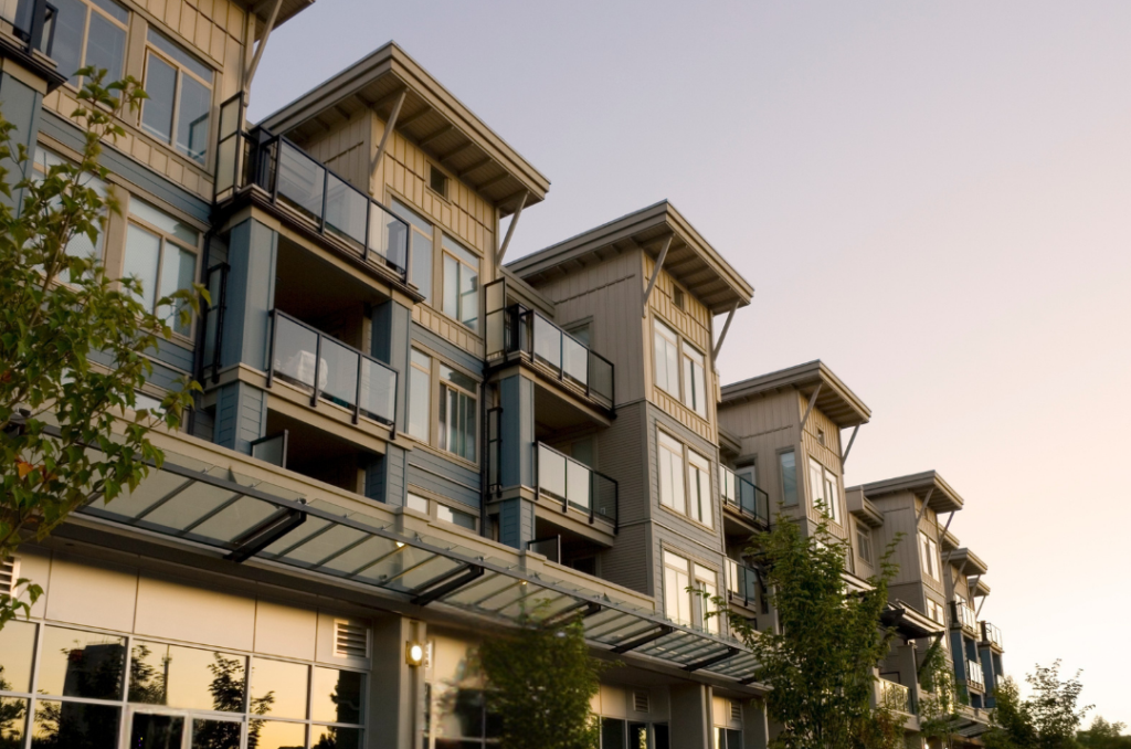 Golden-hour view of Cerritos CA residential neighborhood with modern 3-story townhomes and clean suburban streets