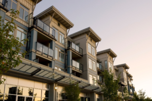Golden-hour view of Cerritos CA residential neighborhood with modern 3-story townhomes and clean suburban streets