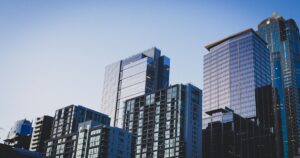 Glass high-rise buildings against a clear evening sky