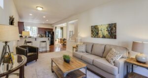 Bright living room with a sofa, chairs and large windows