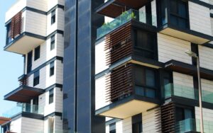 Modern condo building with balconies and wood accents
