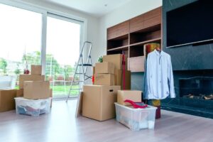 Moving boxes and a ladder in a bright living room