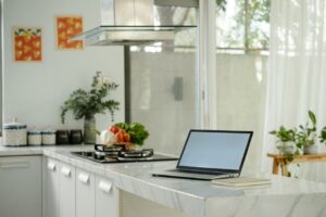 Laptop on a kitchen counter near a window